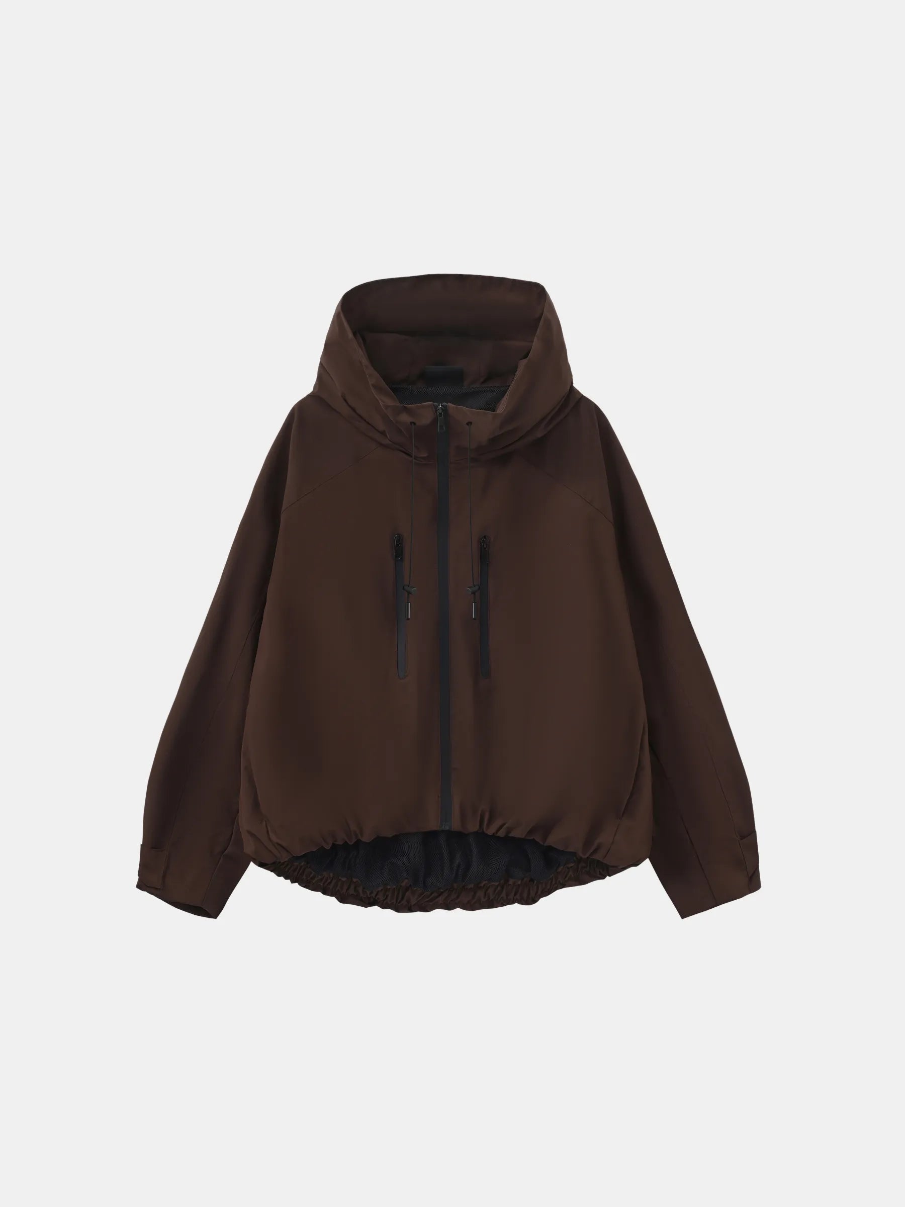 Short oversized rain jacket in black worn over a knit